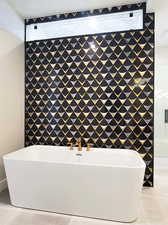 Bathroom with tile patterned flooring and a washtub