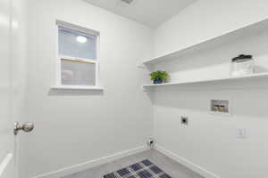 Laundry area featuring hookup for a washing machine and hookup for an electric dryer