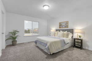 Carpeted bedroom featuring a textured ceiling