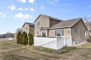 Rear view of house with a lawn