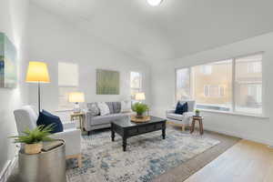 Living room featuring vaulted ceiling and hardwood / wood-style floors