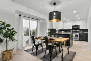 Dining room with sink and light wood-type flooring