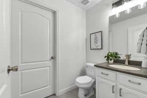 Bathroom featuring vanity and toilet