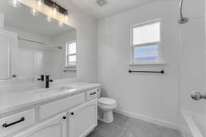 Full bathroom with vanity,  shower combination, and toilet