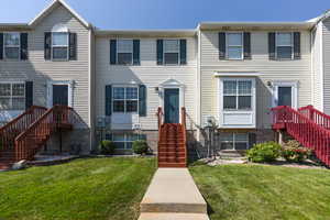 View of property with a front lawn