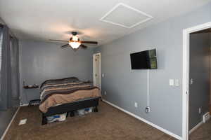 Carpeted bedroom featuring ceiling fan