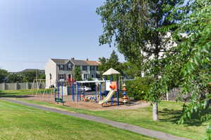 View of play area with a lawn