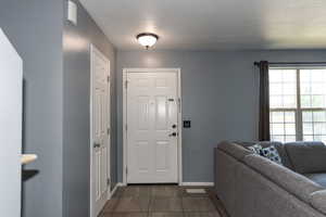 Foyer entrance with dark tile patterned flooring