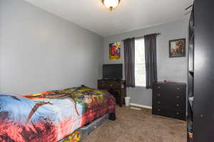 Carpeted bedroom featuring a textured ceiling