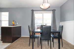 Dining room with light colored carpet