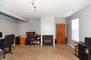 Office space with carpet flooring and plenty of natural light