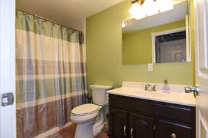 Bathroom with vanity, toilet, and tile patterned floors