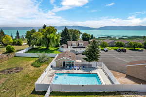 View of swimming pool featuring a mountain view, a patio area, and a yard