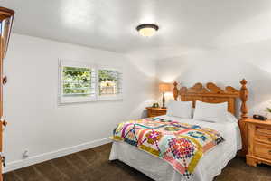 Carpeted bedroom with a textured ceiling