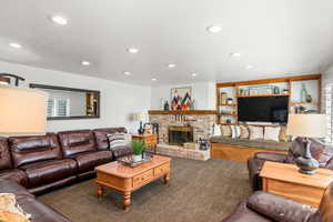 Carpeted living room featuring a fireplace