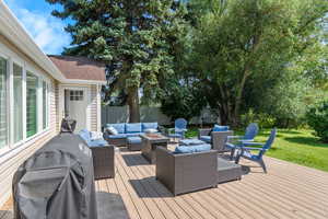 Wooden terrace with outdoor lounge area and a yard