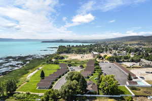 Birds eye view of property with a water and mountain view