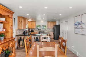 Dining area with light hardwood / wood-style floors and sink