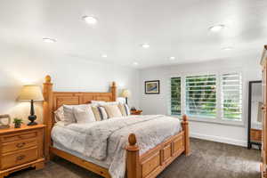 Bedroom featuring dark carpet