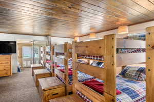 Bedroom with carpet and wooden ceiling