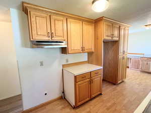 Kitchen featuring light LVP / wood-style floors and a textured ceiling