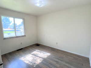 Spare room featuring LVP / wood-style floors