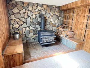 Details with a wood stove and wooden walls