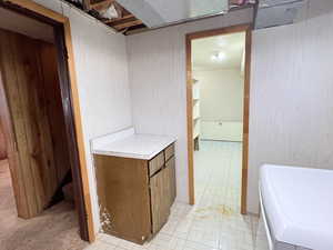 Laundry featuring washer / dryer and tile patterned linoleum flooring