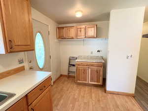 Kitchen with light LVP / wood-style floors