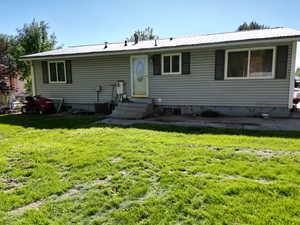 View of back facade featuring a back yard