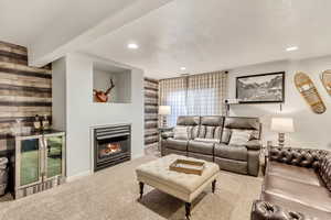 Carpeted living room featuring a textured ceiling