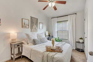 Second bedroom with ceiling fan and vaulted ceiling.