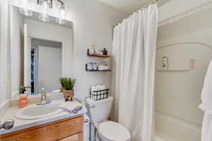 Full bathroom featuring shower / tub combo, toilet, and vanity