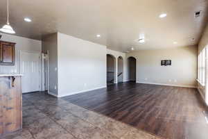 Unfurnished living room with dark hardwood / wood-style flooring