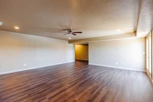 Unfurnished room featuring a textured ceiling, ceiling fan, and hardwood / wood-style floors