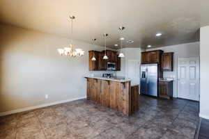 Kitchen featuring tile patterned floors, kitchen peninsula, and stainless steel appliances