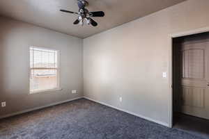 Carpeted empty room with ceiling fan