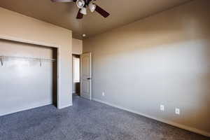 Unfurnished bedroom featuring carpet floors, ceiling fan, and a closet