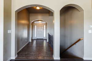 Corridor with dark tile patterned flooring