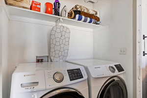 Clothes washing area featuring washing machine and clothes dryer.