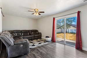 Living room with hardwood / wood-style flooring and ceiling fan