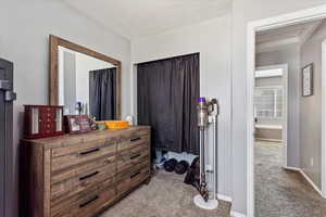 Carpeted bedroom featuring a textured ceiling