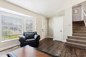 Living room featuring hardwood / wood-style flooring and lofted ceiling