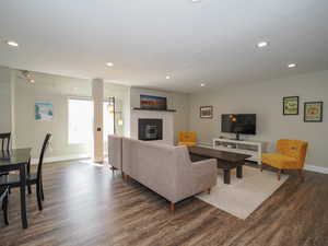 Living room with a fireplace and dark hardwood / wood-style floors