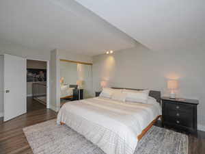 Bedroom with a closet and dark hardwood / wood-style floors