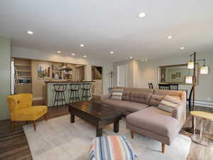 Living room featuring hardwood / wood-style flooring, built in features, and a baseboard radiator