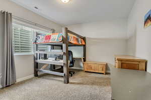 Carpeted bedroom with a textured ceiling