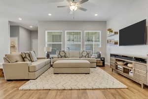 Living room featuring light hardwood / wood-style floors and ceiling fan