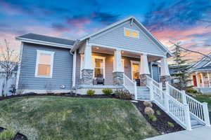 Craftsman-style house featuring a yard and covered porch