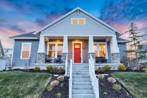 Craftsman-style home featuring a yard and covered porch